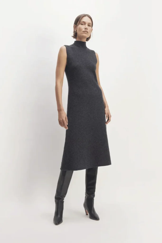 Model wears dark grey sleeveless knit dress