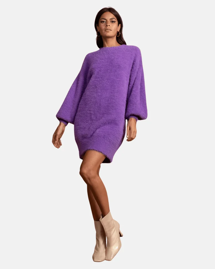 Model wears purple jumper dress