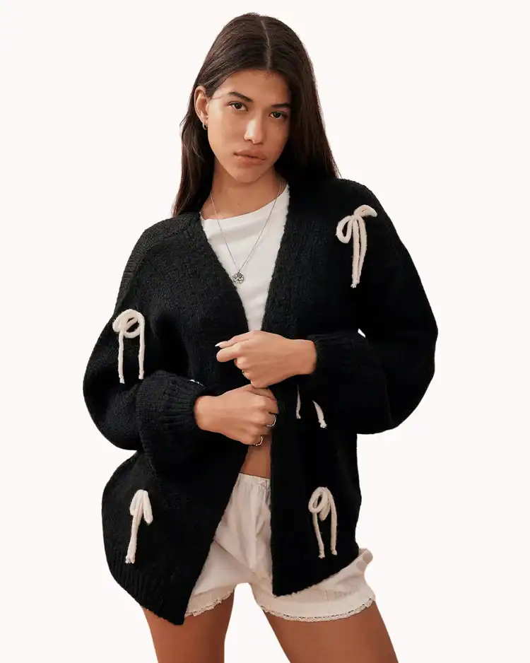 Model poses wearing Bow Knit Cardigan