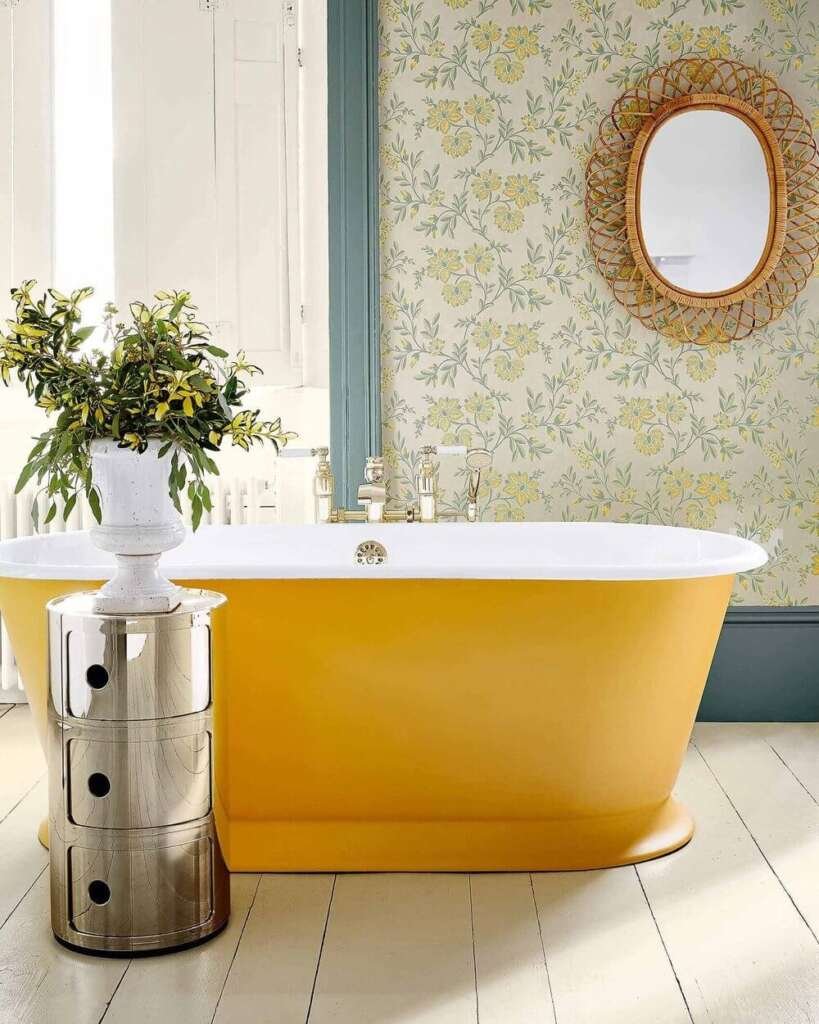 Yellow bath in a bathroom with floral wallpaper