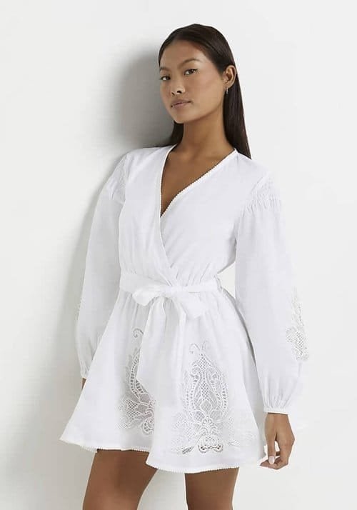 Model wears an Embroidered Wrap Mini Dress. Best Casual White Summer Dresses