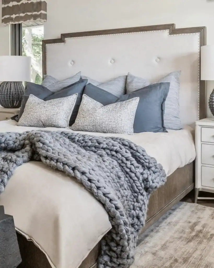coastal bedroom idea with a thick grey knit throw