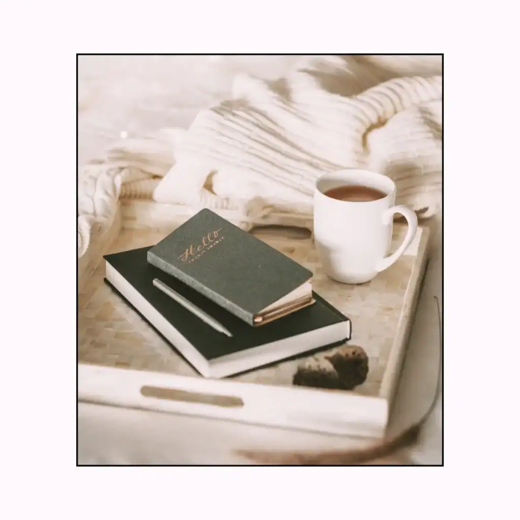 A-cup-of-coffee-and-two-notebooks-inside-a-tray