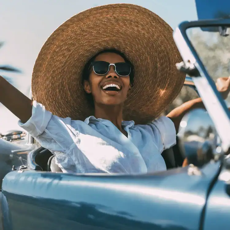 Black-woman-driving-a-vintage-convertible-car.-Saturday-selfcare-ideas