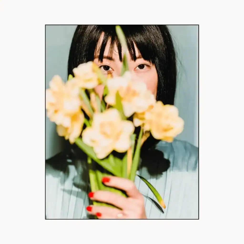 Neo-opulencewomanholdingflowers.Positivity Instagram captions
