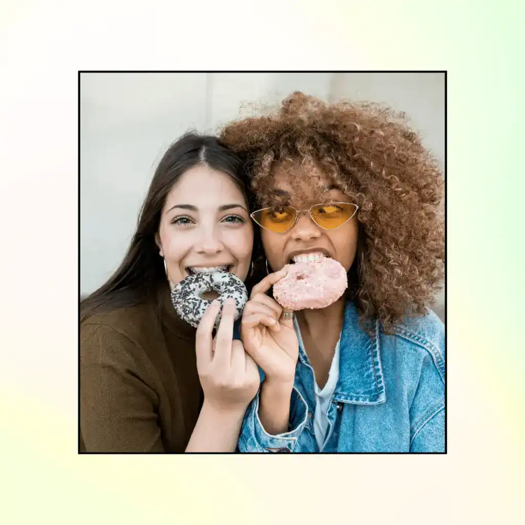 Two-friends-each-eating-a-donut.-How-To-Set-Healthy-Boundaries-With-Friends
