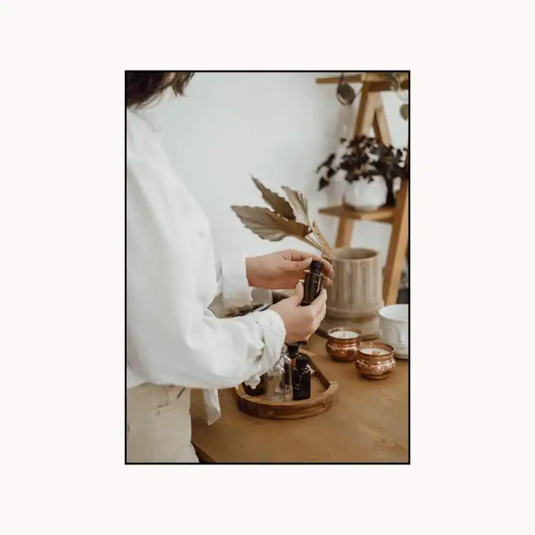 Woman-Preparing-Bottles-of-Scented-Oil-for-Candle-Making
