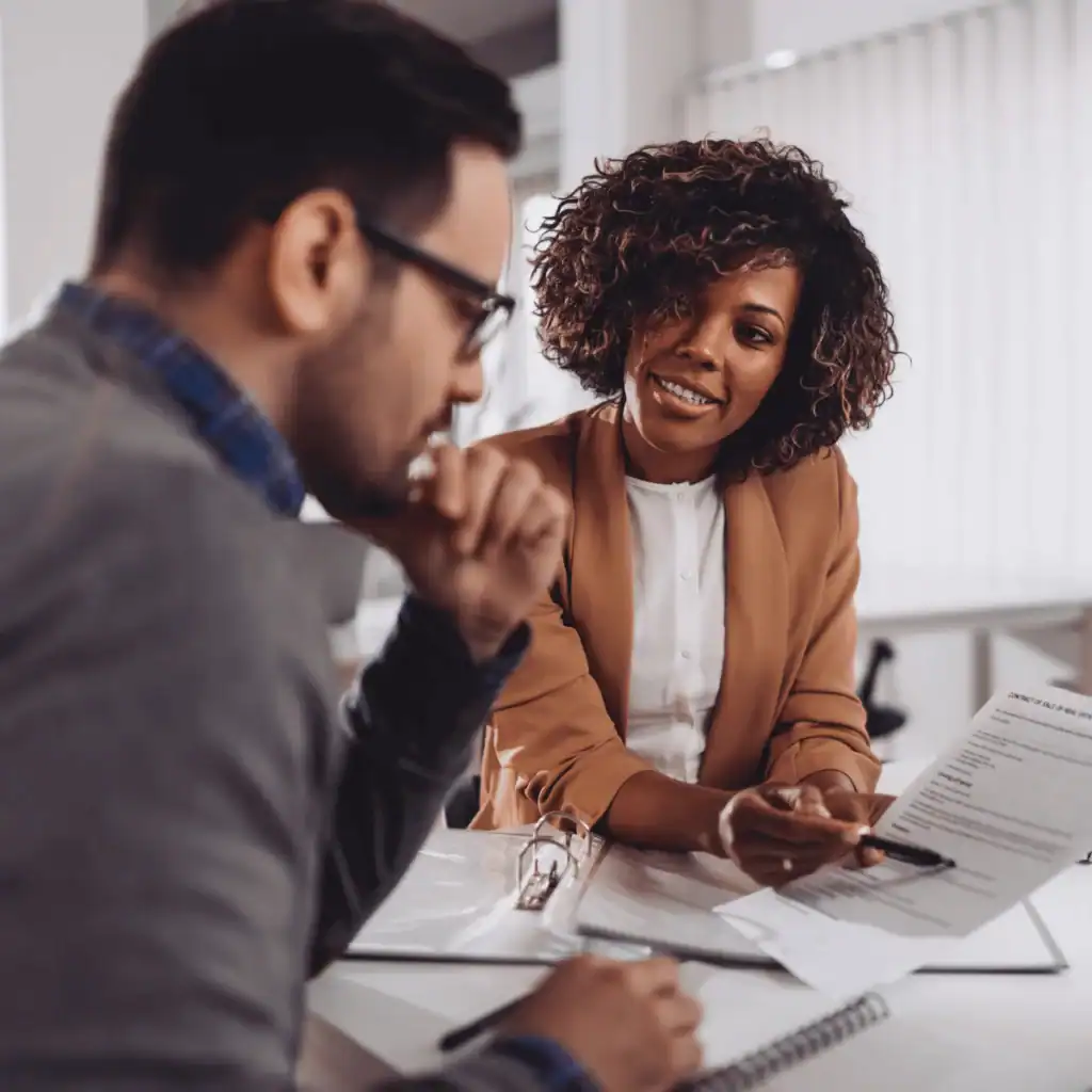 Woman-with-a-paper-and-pen-in-hand-appears-to-explain-something-to-a-man