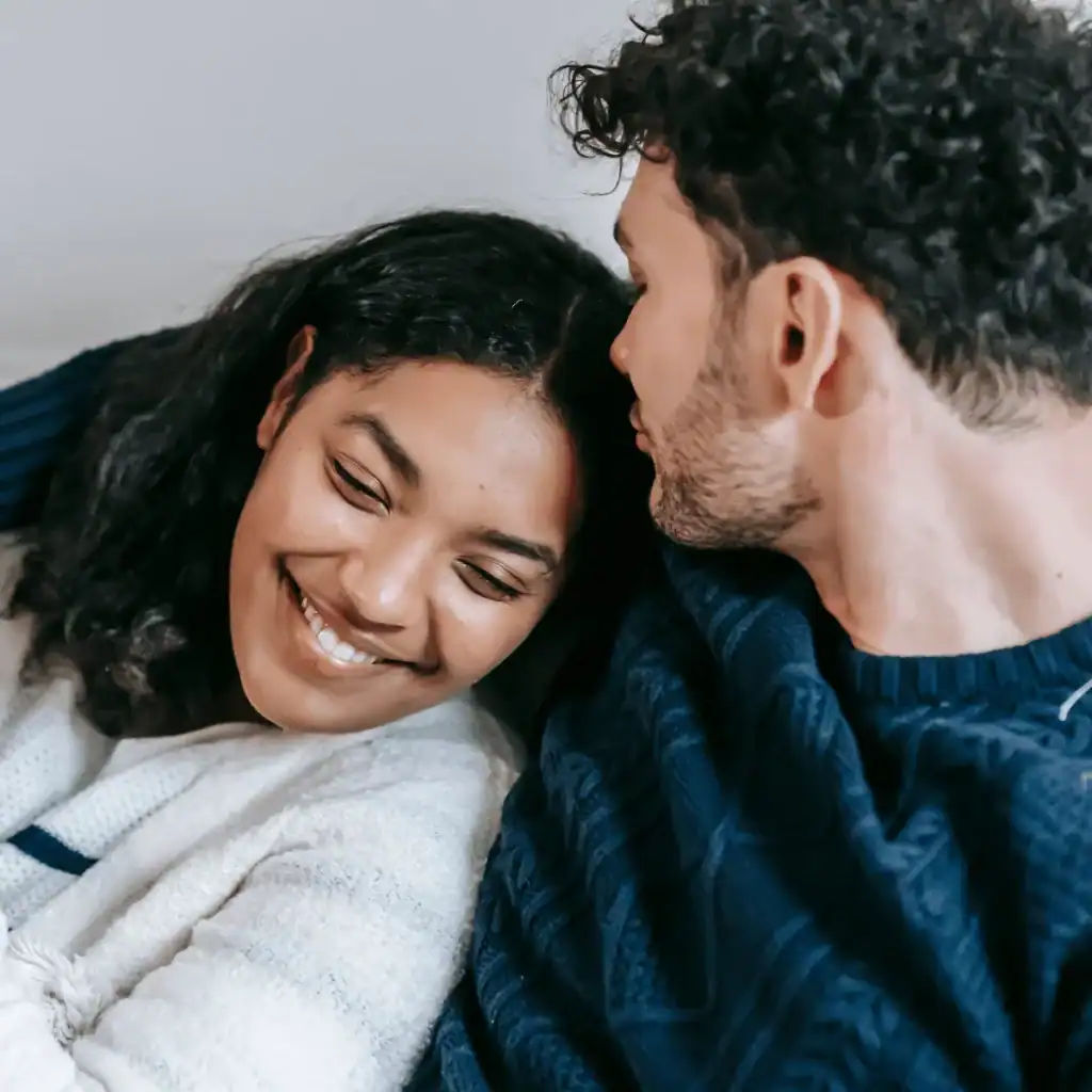 Young-couple-snuggled-up-and-smiling