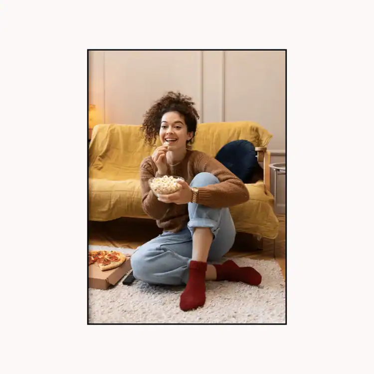 smiley-woman-watching-tv-eating-popcorn.-Saturday-selfcare-ideas