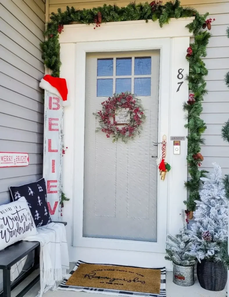 Christmas Front Porch Ideas with a santa hat and garland